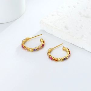 Detailed shot of 925 silver C-shape gold earrings with colorful zircon gemstones