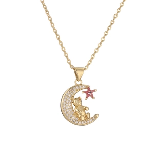 Detail of gold moon pendant with pavé crystals, tiny bear and pink star charm