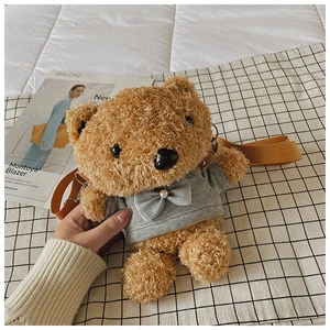 Detailed close-up of cute teddy bear plush bag with grey hoodie and pearl bow detail