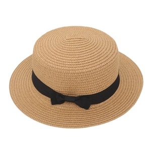 Elegant woven flat top straw sun hat featuring a classic black ribbon and bow decoration
