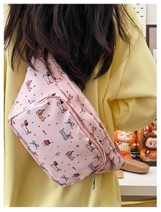 Detail of pink cartoon dachshund crossbody bag showing double metal zippers and straps