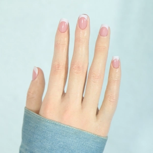 Pink and white French tip press-on nails in medium square shape with glossy finish