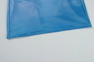 Close-up of the bright blue dress hem featuring precise double-stitch sewing details