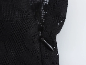 Close-up of black lace fabric detail with high-quality invisible zipper on the side seam