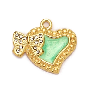 Close-up of gold-plated heart pendant with light green enamel and rhinestone bow detail