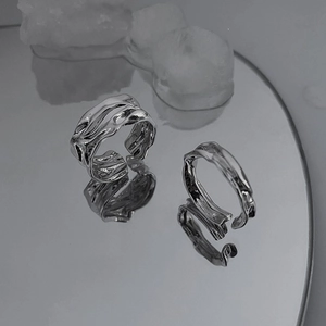 Irregular textured silver open ring set with liquid metal style on a mirrored base