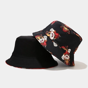 Detail of reversible bucket hat with black side and cartoon cow Chinese pattern
