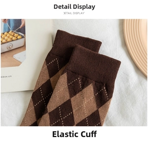 Close-up of elastic ribbed cuffs and argyle knit pattern on brown mid-calf socks