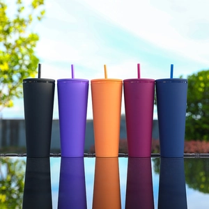 Outdoor shot of five colorful matte double-layer plastic cups with straws and reflections
