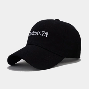 Detailed close-up of white Brooklyn embroidery on a premium black baseball cap
