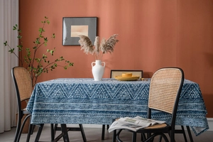 Blue cotton linen tablecloth with white geometric patterns in a cozy dining room setting