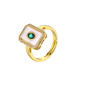 Detail view of 18K gold plated ring with white mother of pearl and green center gemstone