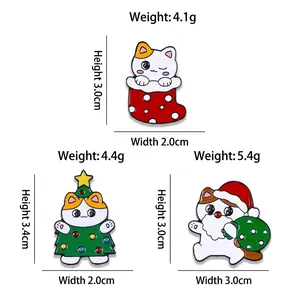 Three cute Christmas cat enamel pins featuring a white cat in a sock, tree, and Santa suit