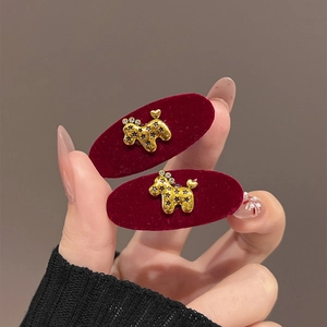 Elegant red velvet hair clips set with gold crystal puppy detail and luxury finish