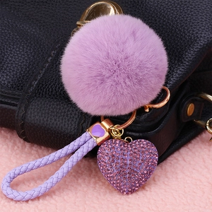 Detailed close-up of a purple faux fur keychain with rhinestone heart and gold hardware