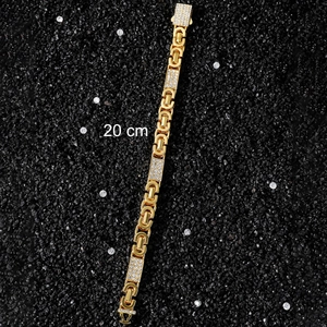 Detail of 20cm gold chain bracelet with geometric links and clear rhinestone accents