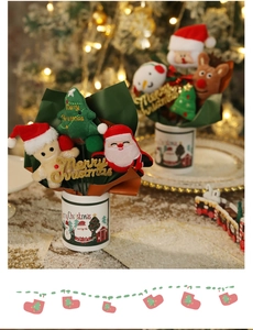 Close-up of plush Christmas dolls bouquet featuring Santa and Gingerbread Man in a ceramic pot