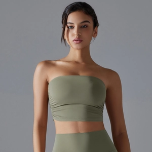 Detail view of olive green pleated tube top sports bra and high-waist yoga set on a model