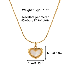 Detailed view of 18k gold heart pendant with shell inlay and technical dimensions
