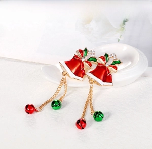 Detail of Christmas bell earrings with red enamel, green leaves and hanging tassels