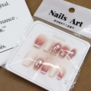 Handmade pink blush press-on nails with silver glitter lines and 3D rhinestones