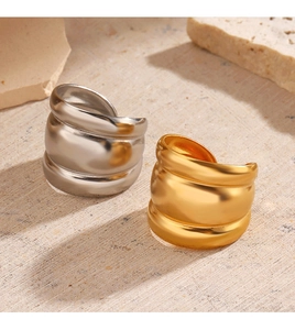 Minimalist wide dome rings in gold and silver finish on natural stone background