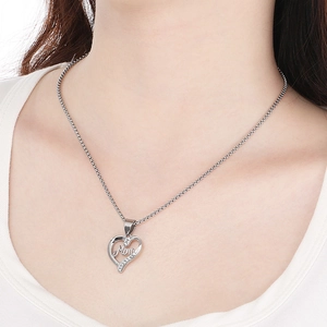 Detail of silver heart Mom pendant with diamonds worn by model on a box chain