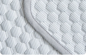Macro view of grey ice silk cooling pet mat showing hexagonal honeycomb texture and edge
