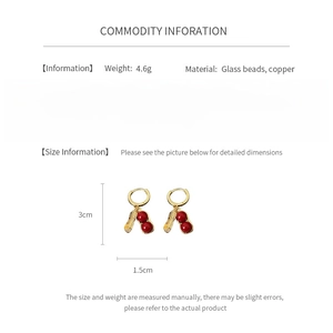 Detailed size and material info for gold-plated peanut earrings with red glass beads