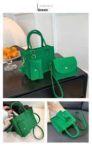 Detailed view of green textured tote bag set with crocodile pattern and golden hardware