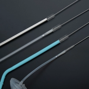 Straw cleaning brush set with stainless steel and plastic straws on black background
