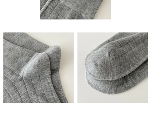 Detail view of grey ribbed knit texture and stitching on ballerina style slouch socks