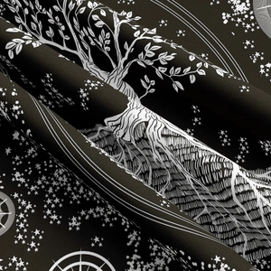 Detailed close-up of tree of life print on black and white celestial tapestry fabric