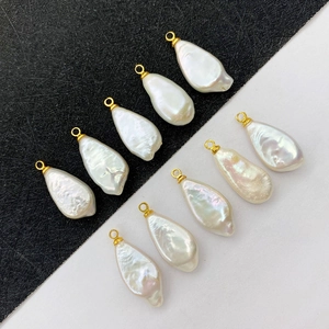 Baroque irregular freshwater pearl pendant with gold clasp on black and white background