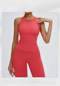 Detail of coral red yoga set featuring hollow cross back vest and high waist leggings