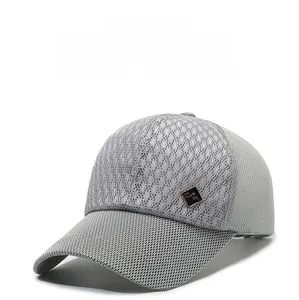 Close-up of breathable mesh fabric and black metal plate on a light grey baseball cap