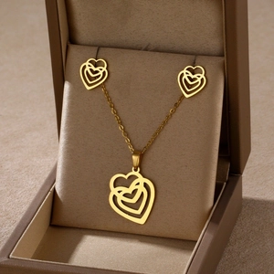 Golden heart necklace and earrings set presented in a premium jewelry box