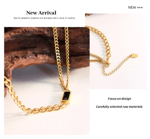 Detail of 18K gold-plated chain necklace with black rectangular pendant and lobster clasp