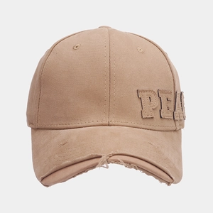 Detailed close-up of khaki distressed cotton baseball cap with raw edge brim and embroidery