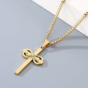 Detail of a gold stainless steel cross necklace with snake motif on a box chain