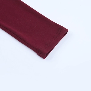 Detailed close-up of burgundy square neck jumpsuit cuff showing fine knit stitching