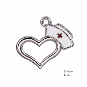 Silver heart pendant with white enamel nurse hat design and red cross detailing