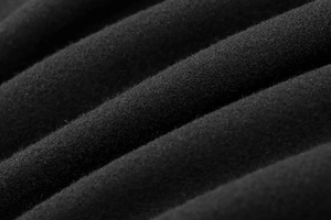 Macro shot of black wool fabric texture and soft fiber details for bomber jacket