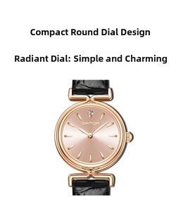 Detailed close-up of rose gold watch face with black leather strap and rhinestone accent