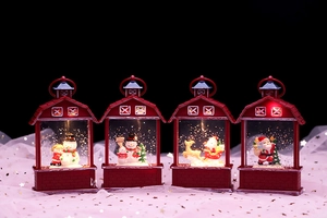 Close-up of four red Christmas lanterns with santa and snowman figures glowing inside