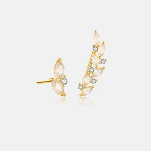 Macro detail of asymmetric branch earrings with pink marquise stones and white zircons
