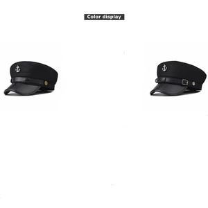Detail of black wool sailor hats featuring silver anchor emblems and leather straps