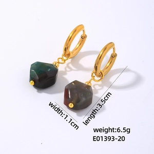 Detailed view of gold geometric drop earrings featuring faceted green natural stone charms