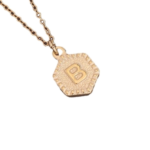 Polished gold hexagon pendant necklace with embossed letter B on a delicate cable chain