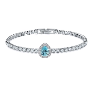 Detail of silver tennis bracelet with pear-cut blue gemstone and round zircon pavé